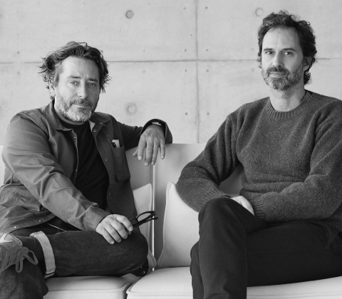 A portrait of Edward Barber and Jay Osgerby sitting on a sofa