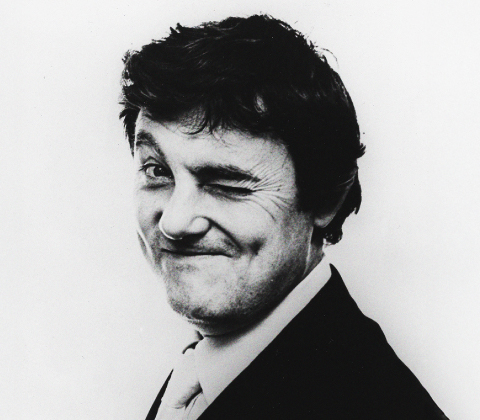 A portrait of Tobia Scarpa winking at the camera